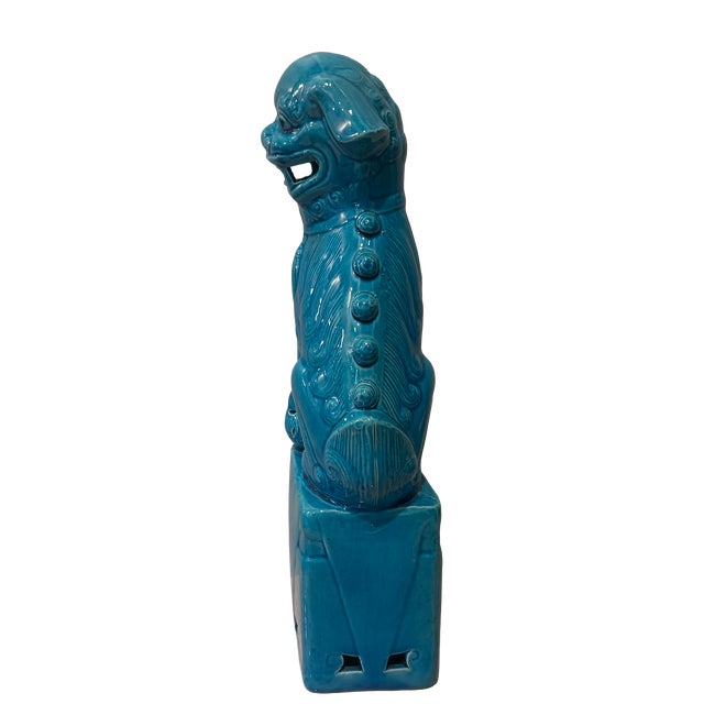A striking, larger-scale, turquoise-glazed ceramic foo dog sculpture, perched atop a geometric pedestal base. At nearly 13...