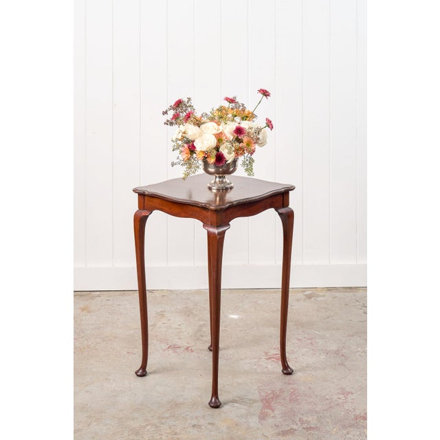 This square mahogany scallop side table features a soft scallop edge, curved cabriole legs and pad feet. Ideal for a side...