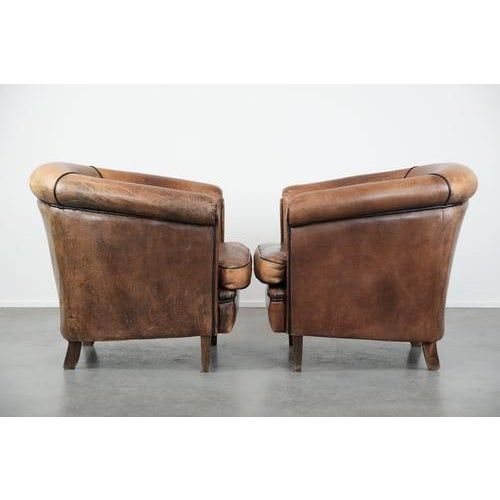 We are offering this set of two sturdy vintage sheepskin club chairs with a beautiful patina. These delightful sheepskin...