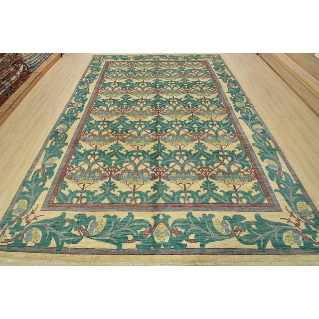 A traditional William Morris rug hand-knotted with fine wool on a cotton foundation. This rug features a botanical pattern...