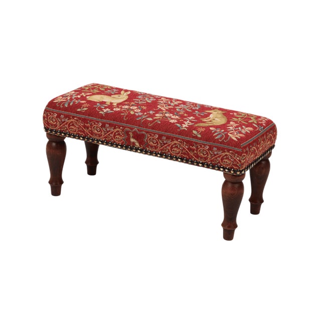 Meticulously handcrafted in the United Kingdom, this upholstered stool boasts classic studding and hand-polished solid...