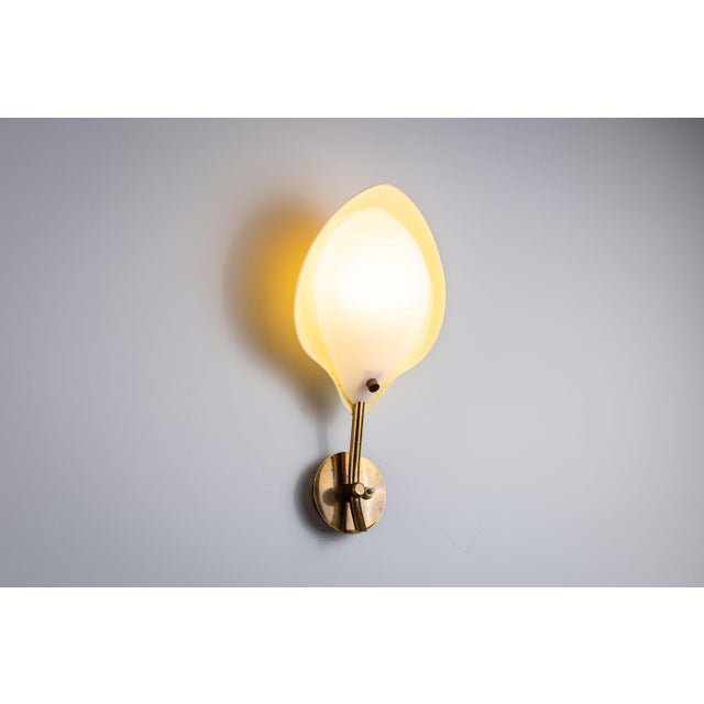 This striking wall lamp is a rare example of mid-century Scandinavian design, crafted by Arnold Wiigs Fabrikker, a...