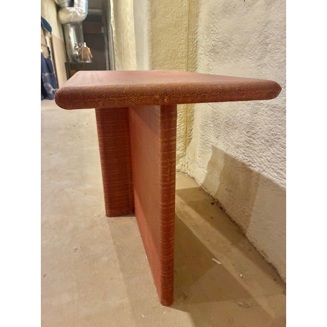 A 1970's side table, wrapped in brick colored, textured raffia.. This table has an unusual Geometric Architectural form....