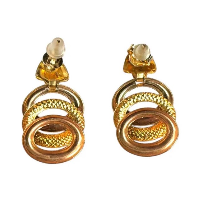 Vintage 18K Yellow Gold Dangle Earrings. Earrings showcase a sculptural design of interlocking circular forms and richly...