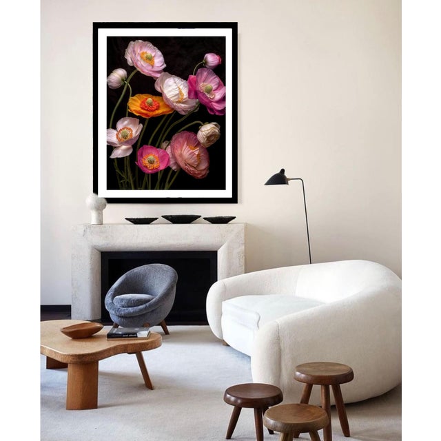 This photograph showcases a bouquet of delicate, vibrant poppies in various shades of white, red, yellow, and pink, set...