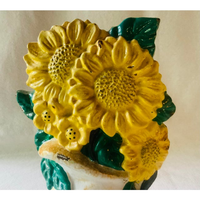 # Chairish Listing — Sunflower Pitcher Doorstop ## Title Vintage 1940s Cast Iron Sunflower Doorstop, Hand Painted Flowers...