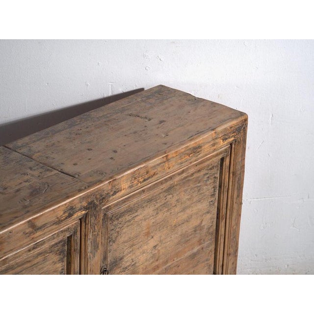 Tall chinese sideboard in solid pine wood, with two doors and two inner shelves decorated, originally from gansu province...