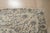 A hand-knotted wool rug, made in India and measuring 4' x 6'. Floral drawing carried across the field inside a traditional...