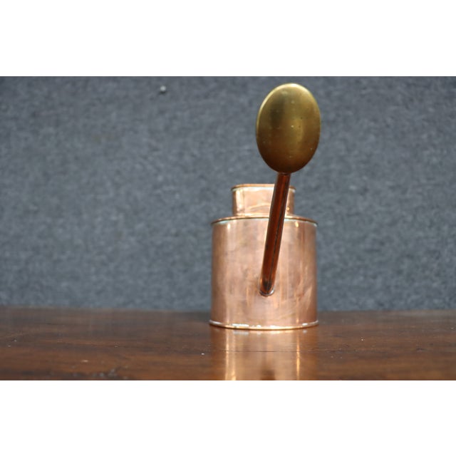 A classic vintage Haws indoor watering can crafted from copper with a brass watering rose, embodying the timeless English...