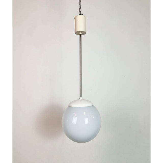 Vintage chandelier made by Elektrosvit in former Czechoslovakia during the 1960s. Made of milk glass ,chrome and bakelite....