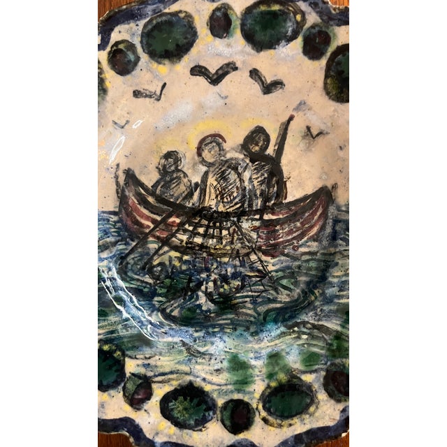 A glazed terracotta plate depicting the miraculous catch of fish by the apostles Peter, James, and John. Splendid colors...