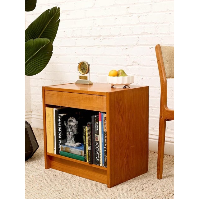 A handsome Danish mid-century nightstand with a warm wood finish and a beautifully understated silhouette. The design...