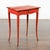 A French Restauration period red side table from the early 19th century, with curving legs and single drawer. Created in...