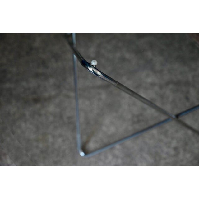 The large hexagonal glass top of this dining table is supported by a superb chrome-plated Eiffel tubular metal base. The...