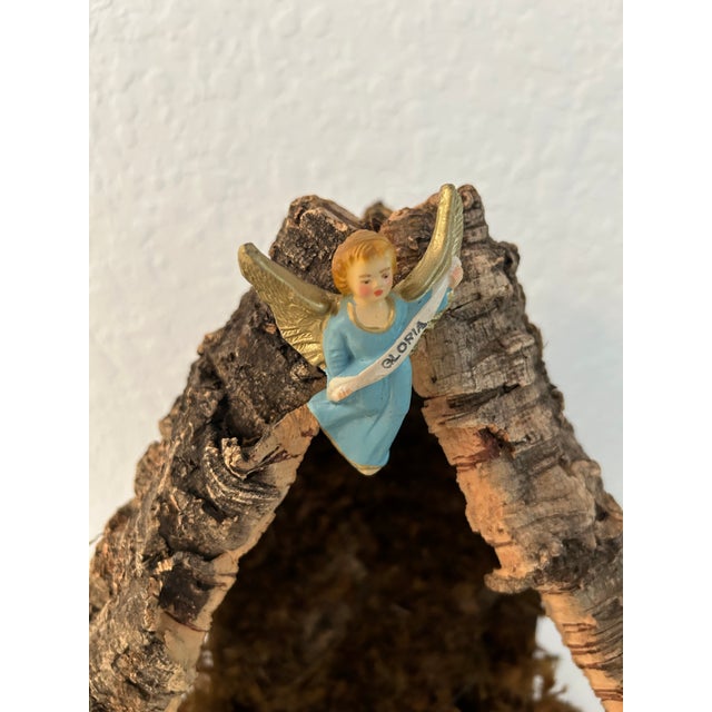 Lovely hand-made generous size Italian nativity featuring a wood frame overlaid with natural tree bark and decorated with...