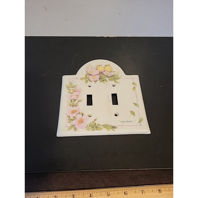 Beautiful porcelain double switch plate cover signed by the artist. Beautiful floral and bird details.