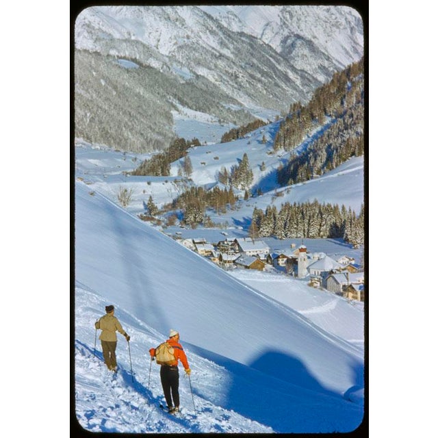 An Alpine Valley In Winter 1955 Two skiers look down into the valley at the St. Anton ski resort, Austria, 1955. Toni...