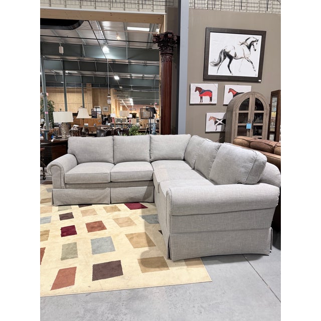 This is a refined Drexel Heritage sectional sofa upholstered in a sophisticated greige textured fabric with a soft linen-...