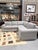 This is a refined Drexel Heritage sectional sofa upholstered in a sophisticated greige textured fabric with a soft linen-...