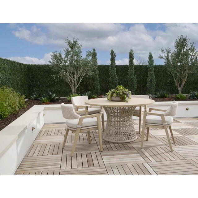 The Lucia Olefin Fabric Outdoor Dining Chair combines solid teak construction with tightly woven synthetic wicker for...
