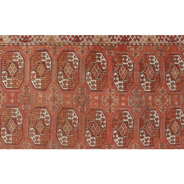 Measures: 8'0 x 18'10 Antique Tekke Rug with Gul Motif in Rich Coral and Ivory Tones 8'0 x 18'10. Keivan Woven Arts/...