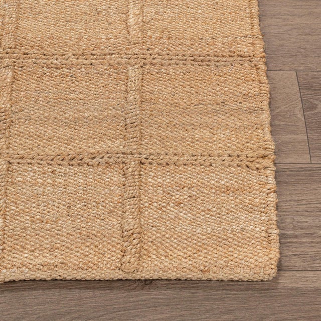 Woven jute rug in warm natural color. Square lattice pattern adds subtle texture and dimension. Available in numerous...