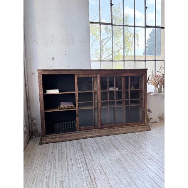 Antique sideboard, a piece of shop furniture with an extra-large size. Formerly a grocery store shelf, we love its...