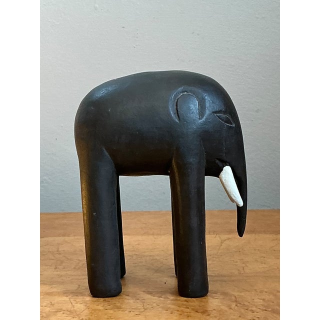 This vintage wooden elephant figurine captures the clean, pared-back spirit of Mid-Century Modern design. Hand carved from...