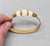 Circa early 1970s goldtone 3 carved faux-ivory pieces cuff bracelet with hinged hook clasp. Marked crown "TRIFARI©" on the...