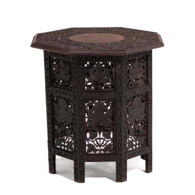 An octagonal teak Anglo Indian folding tea table or tabouret from the late 19th to early 20th century. Intricately carved...