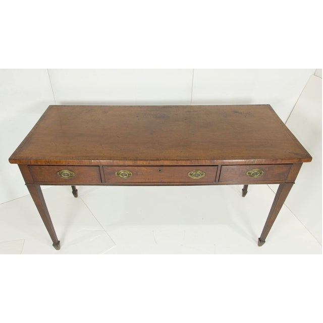 An elegant circa 1810 Sheraton sideboard, crafted in richly figured mahogany and distinguished by the restrained symmetry...