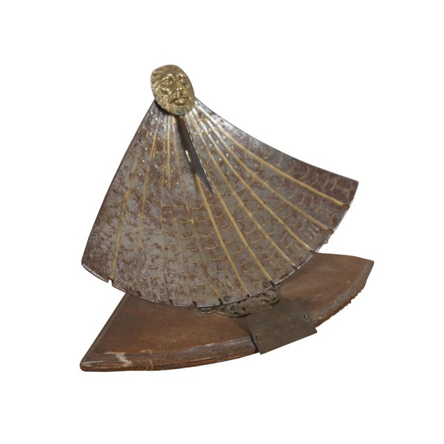 Mid 20th century souvenir reproduction of an ancient Roman sun dial. Fan shaped metal dial plate, decoratively aged, with...
