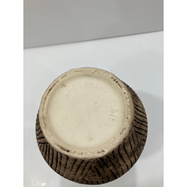 This pottery vessel was made in West Germany In the 50’s The style is influenced by prehistoric designs inspired by...