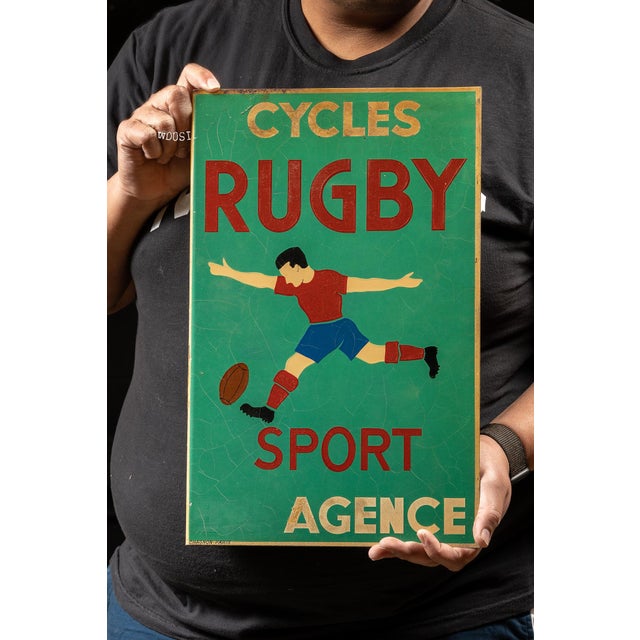 1950s-1960s; Chagnon - Paris, France Double-sided porcelain enamel sign advertising Cycles Rugby, Sport Agence. The sign...