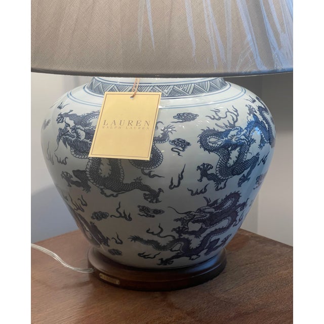 New with tags - a pair of Lauren Ralph Lauren porcelain table lamps featuring an all over blue and white dragon motif on a...