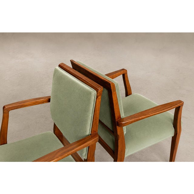 : This elegant pair of Brazilian armchairs combines architectural clarity with the warmth and expressive character of aged...