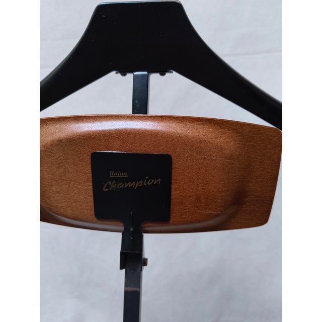 Practical, foldable clothes rack made of brass and black lacquered metal from the mid-20th century. This piece is...