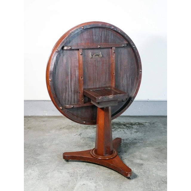 Sailing table in mahogany wood, with central leg ending tripod, with wheels. England, twentieth century England origin...