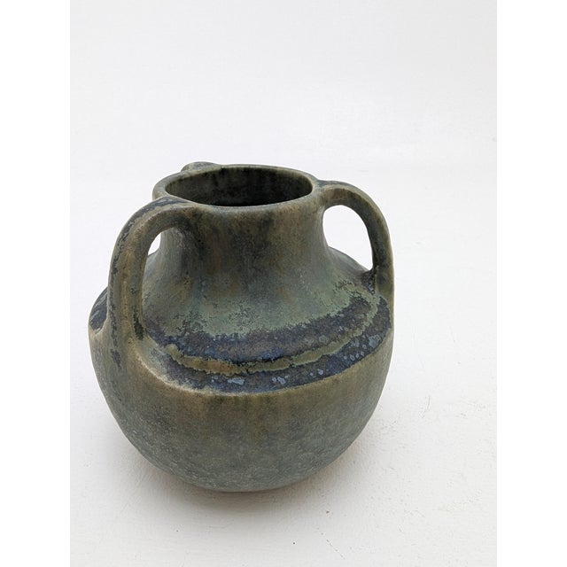 A delightful little Art Nouveau ceramic collector's vase with three handles and a green iridescent glaze, as well as a...