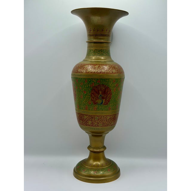 A striking vintage brass vase marked India on the bottom, featuring an elegant pedestal form, flared trumpet rim, and...