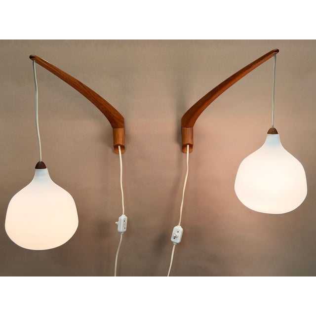 Scandinavian wall lamp, model 705, attributed to Uno & Östen Kristiansson for Luxus Vittsjö, Sweden, 1950s. Elegantly...
