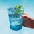 Handmade colored tumblers in mass-colored glass, blown in light shades with a spiral of "lattimo" glass threads applied...