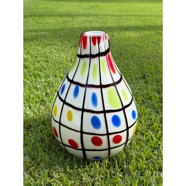 Striking vintage art glass vase featuring a bold graphic grid pattern with colorful red, blue, yellow, and lime-green...