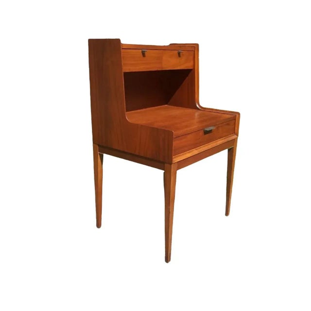 Vintage Side table designed by Arthur Umanoff featuring tall legs and three drawers in a two-tier fashion. Whether its the...