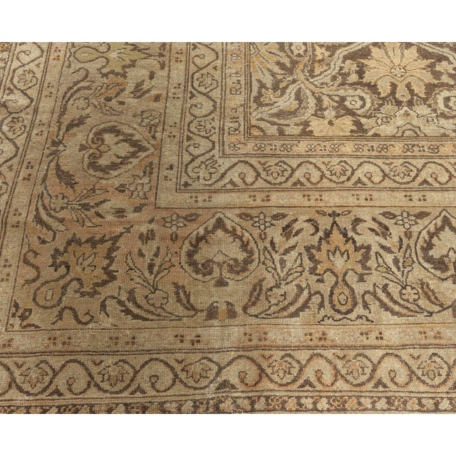 An early 20th century Indian Amritsar antique rug, the light brown field with a luxurious beige allover trellis of...
