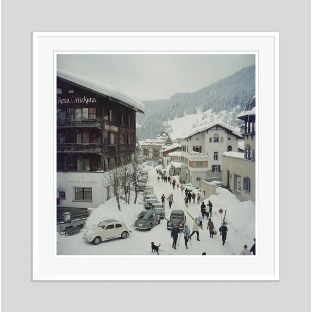 Klosters' by Slim Aarons Open Edition Skiers pass by the Hotel Chesa Grischuna in Klosters, 1963. (Photo by Slim Aarons)....