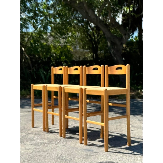 Elevate your space with this charming set of four Vintage Boho Rush Seat Bar Stools, a perfect blend of rustic...
