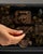 This 20th century Chinese black lacquered box with brass mounts from Asia is finished in black lacquer and painted with...