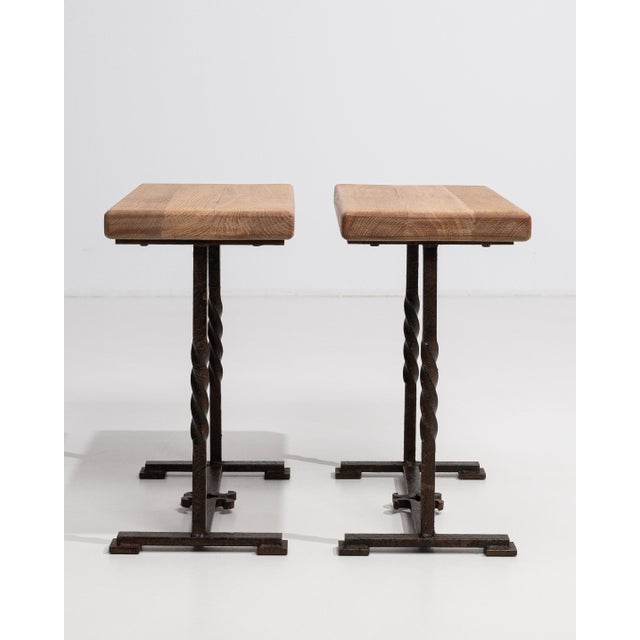Originating from France and dating to circa 1970, this distinguished pair of oak side tables exemplifies the clean,...