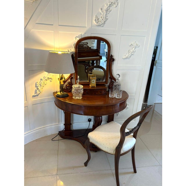 Antique Victorian quality mahogany dressing table having an adjustable swing mirror supported by two shaped carved...
